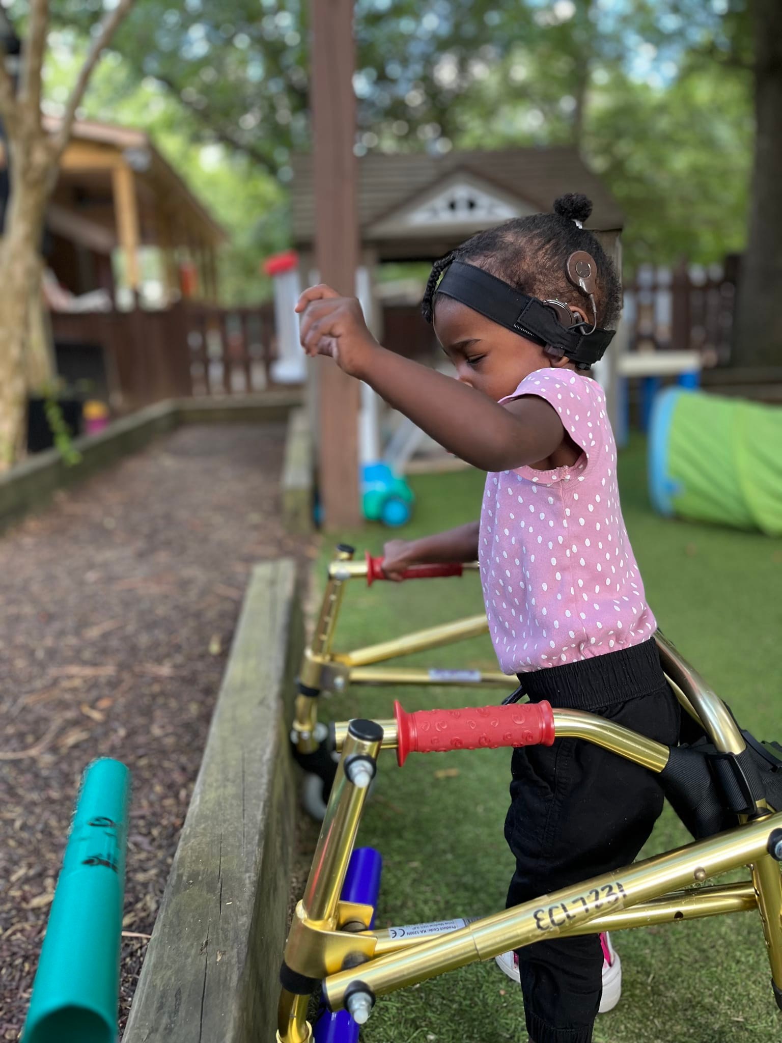 toddler playing at garden bed